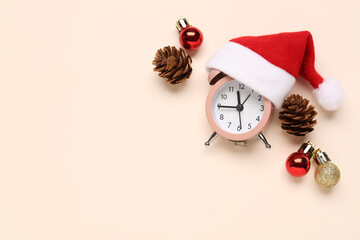 Composition with alarm clock, Christmas decorations and cones on color background