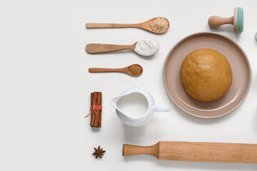 Composition with ingredients and utensils for preparing tasty Christmas cookies on light background