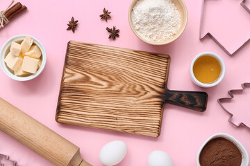 Fototapeta na wymiar Composition with kitchen utensils and ingredients for preparing Christmas cookies on pink background