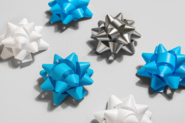 Christmas composition with colorful bows on grey background