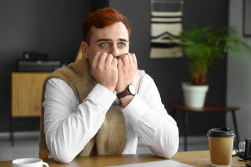 Fearful young businessman in office