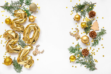 Figure 2024 made of foil balloons with coniferous branches and beautiful Christmas decorations on...