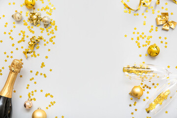 Christmas balls with bottle of champagne and glasses on white background