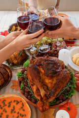 Group of young friends drinking punch at festive table on Thanksgiving Day, closeup