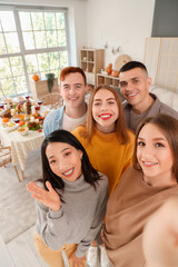 Group of young friends taking selfie on Thanksgiving Day