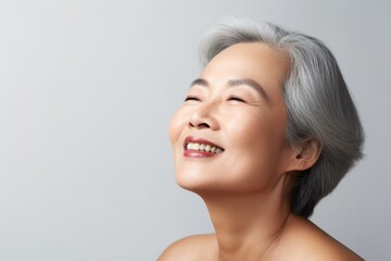 Fototapeta premium Portrait of a happy senior woman with closed eyes and closed eyes