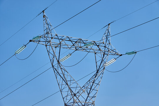 High Voltage Tower Soaring Against a Clear Blue Sky