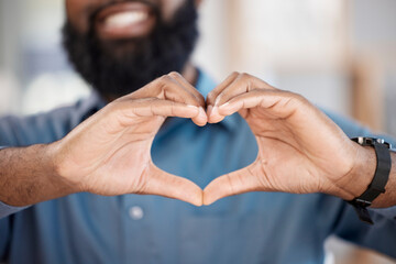 Man, hands and heart with gesture in closeup, alone and blurred background. African, person or model with love, hope or support for community in solidarity with human rights, social justice or change