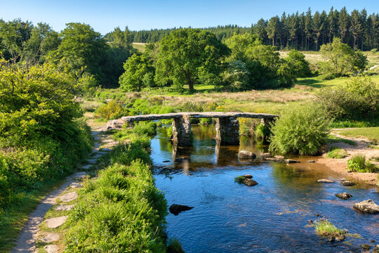 Old clapper bridge over the West Dart river at Postbridge, Dartmoor, Devon, UK.