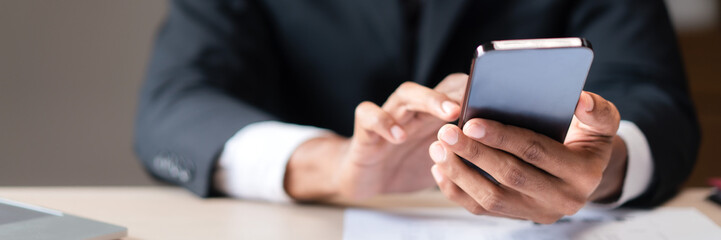 Closeup hands of businessman using smartphone to researching data and analyzing strategy of startup