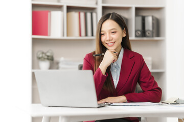 Asian people independent investment consultant captured in her element at office, donning vibrant...