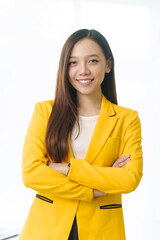 Confident female Asian china people advisor specializing in studying abroad, donning vibrant yellow suit, guiding students toward international education opportunities in global institutions.