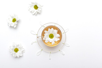 Cup of hot chamomile tea isolated on white background.