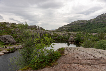 Mountain lake on the side of the tourist route to Preikestolen rock. Norway