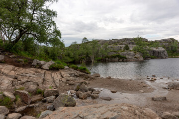 Mountain lake on the side of the tourist route to Preikestolen rock. Norway