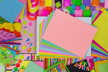 Overhead workspace background. Variety of art supplies on background with blank space for your design.