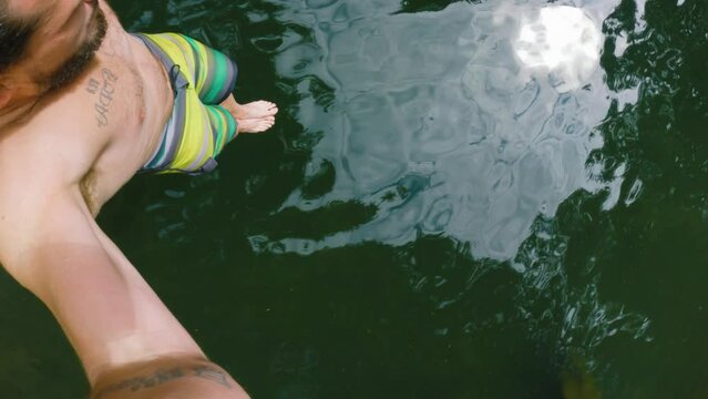 POV of Man Cliff Jumping Holding Selfie Camera