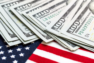 Dollar bills on the american flag. Close up.