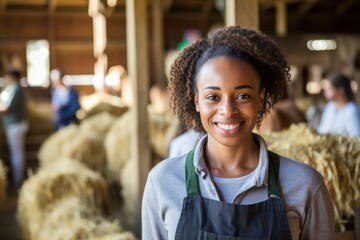 Beautiful African young woman worker working in a cow barn on the farm. Modern cow farmers work with tablets.