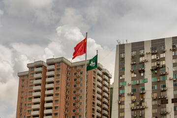 Flags of China and SAR Macau in front of residential buildings in Macau, China