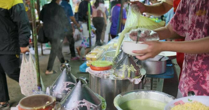 Old asian woman make Thai dessert in morning tradition market
