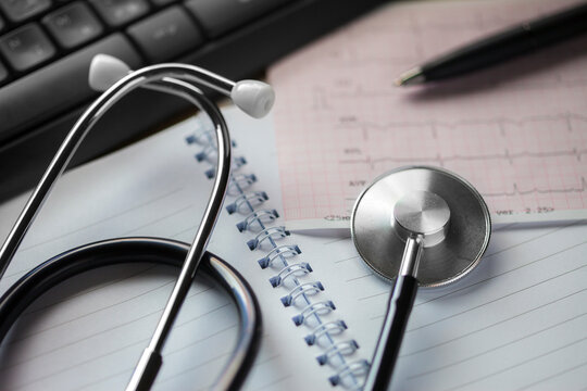 Stethoscope and medical documents. Selective focus. Blue tone image. Medical and healthcare concept.