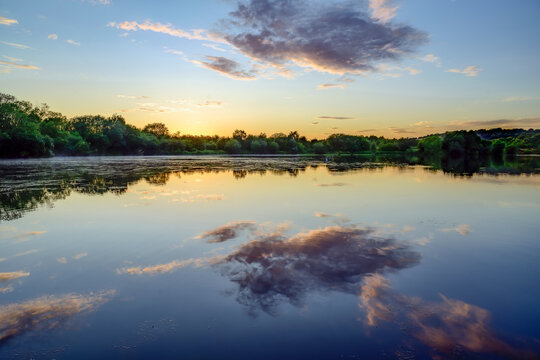 Magical sunset over the lake, reflection in the water, Treeton Dyke