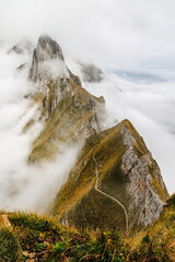 The most spectacular trekking trail at the Schaefler of Alpenstein mountains in early autumn morning fog.