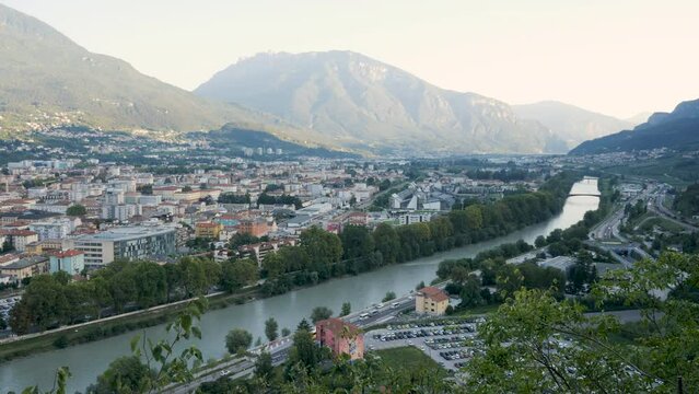 Trento, Italy, landscape of the Adige river and the town at sunset