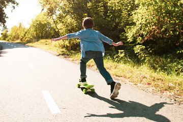 Kid having fun with penny board. Hobby favorite activity