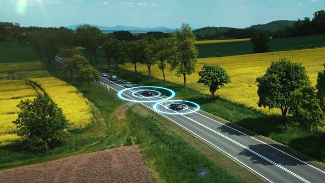 Self driving autonomous electric cars on a country highway with technology assistant. Sensor Scanning Road. Smart transportation of the future. Visualization with HUD elements. Aerial view. 4k footage