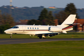 Private Jet airplane landing on a runway