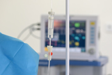 A drip with saline solution in the operating room close-up. Syringe pump with blurred medical equipment background.
Intravenous fluid infusion for a patient with blood loss during surgery.