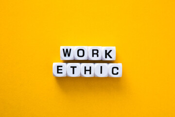 Work ethic words on yellow background.