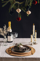 winter holidays, dinner party and celebration concept - scandinavian christmas table serving with burning candles at home over black background