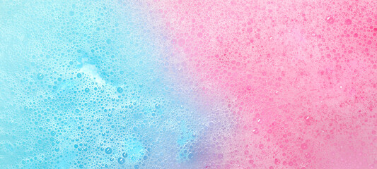 Colorful foam after dissolving bath bomb in water, closeup. Banner design