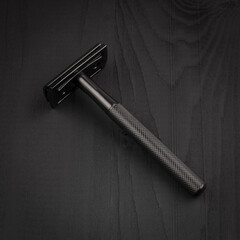 Classic men's shaving machine. Shaving accessories. Safety razor on a black background.