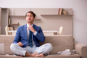Young male employee working from home during pandemic