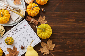 Build a Thanksgiving table that leaves a lasting impression. Top view photo of calendar, plates,...