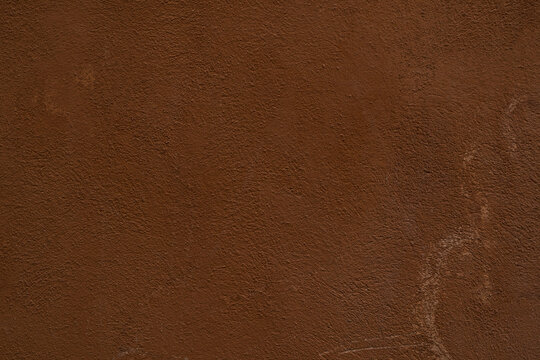 Dark terracotta mediterranean old wall plaster rough texture background