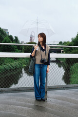 Lonely woman holding an umbrella in the rain