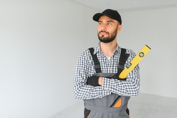 Young worker making repair in room.