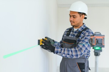 Indian worker makes repairs in an apartment
