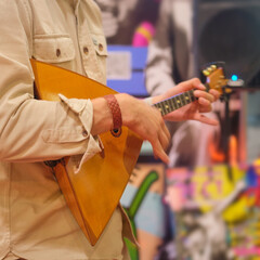 Man playing balalaika in music store. Close-up.