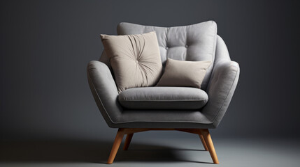 A grey armchair with four wooden legs and a white cushion