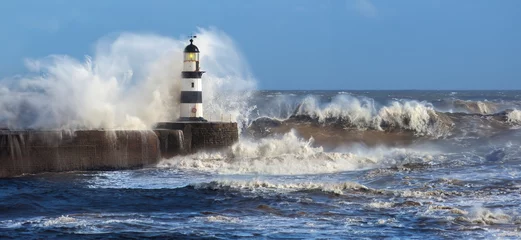 Fotobehang Waves crashing over Seaham Lighthouse in the northeast of England. © mrallen