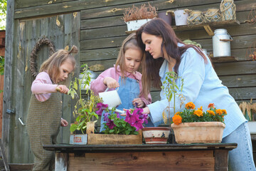Exploring gardening wonders, a mother and daughters plant together, cultivating love and learning. A serene moment capturing the essence of discovery and unity