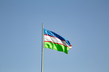 flag of Uzbek country flying in the Wind in highest pole