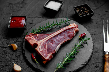 raw T-bone steak on stone background