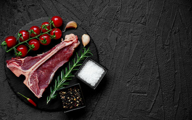 raw T-bone steak on stone background with copy space for your text